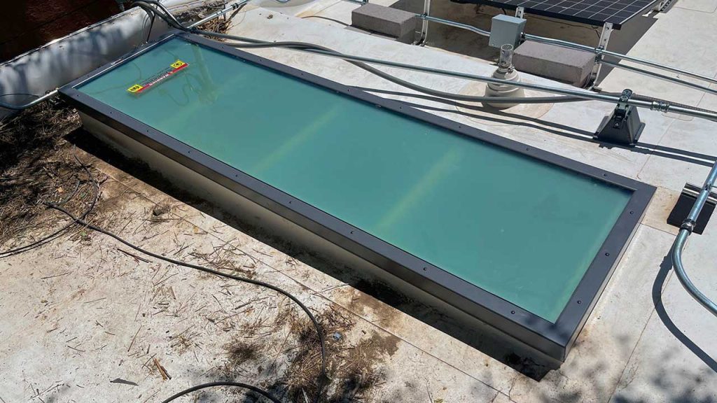 An image of the 2 foot by 6 foot replacement glass skylight on the roof.